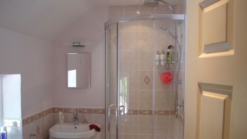 Walk-in shower cubicle in finished bathroom installation