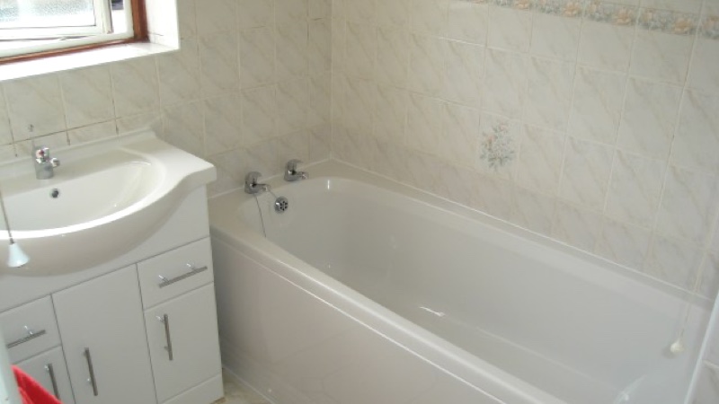 White Bath and sink in finished bathroom installation