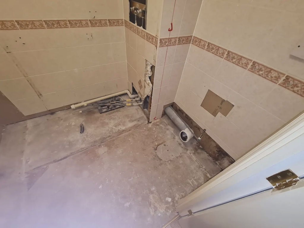 Stripped-out bathroom during refurbishment